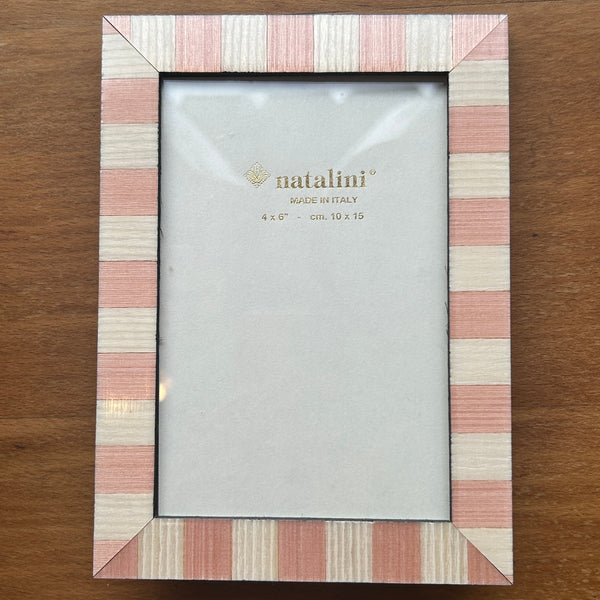 A rectangular picture frame with a striped border in pink, beige, and white, holding a blank light gray insert. The brand name 'natalini' is printed in gold on the insert.