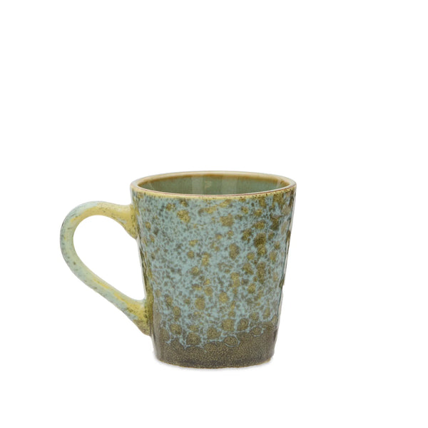 A handmade ceramic mug with a textured, speckled glaze transitioning from a light blue-green at the top to a warm brown at the base, featuring a rustic yellow-green rim and handle.