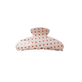 Polka dot hair clip on a white background