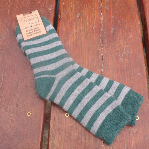 A pair of striped men's socks in grey and green, displayed on a wooden surface.