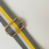 Crossbody grey bag strap with a yellow stripe